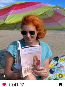 Ana, de Objetivo Birmania, leyendo "Demasiado tarde para comprender" en un playa de Almería en octubre de 2024.